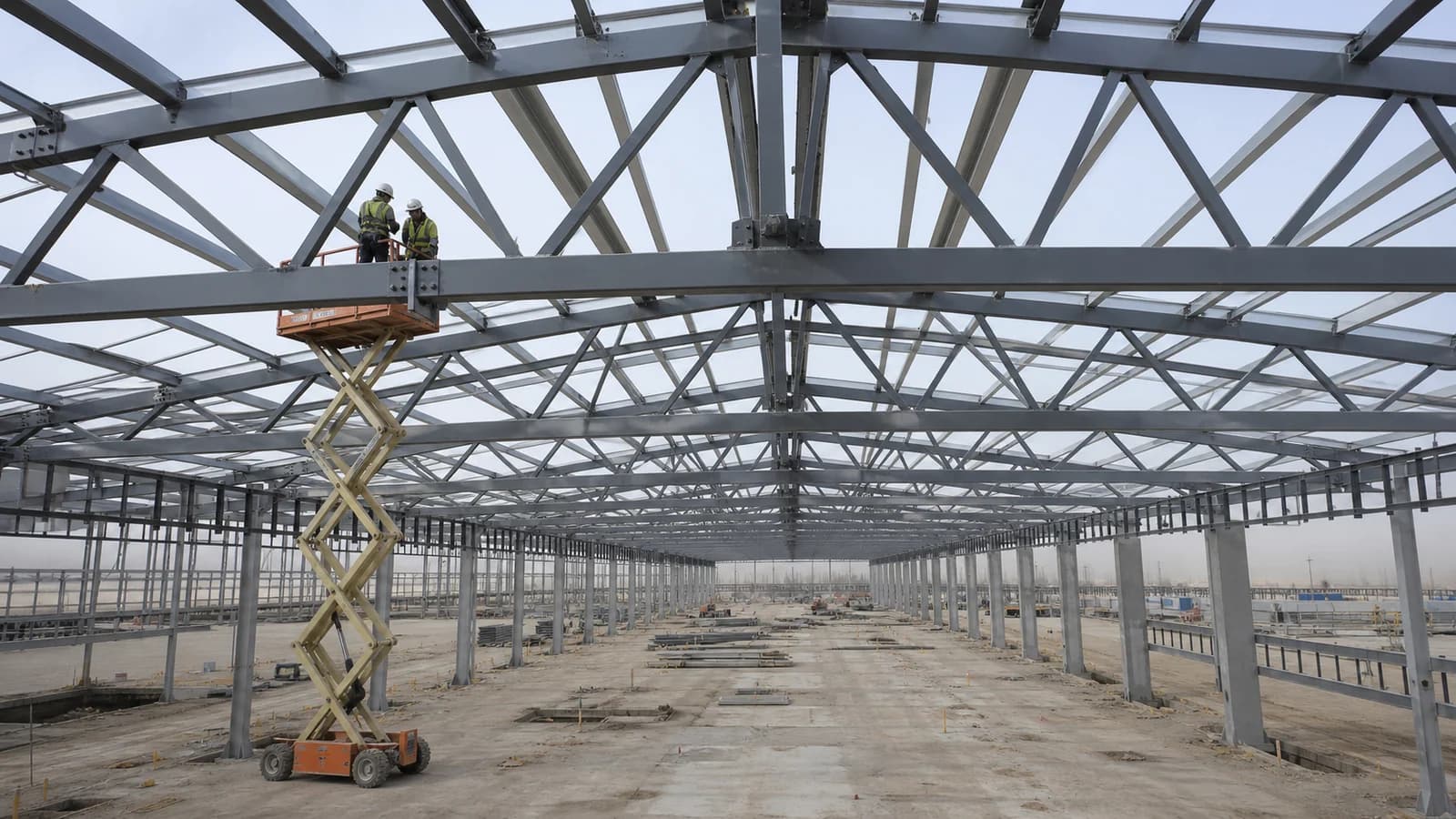 Long-span structural steel roof frame under construction